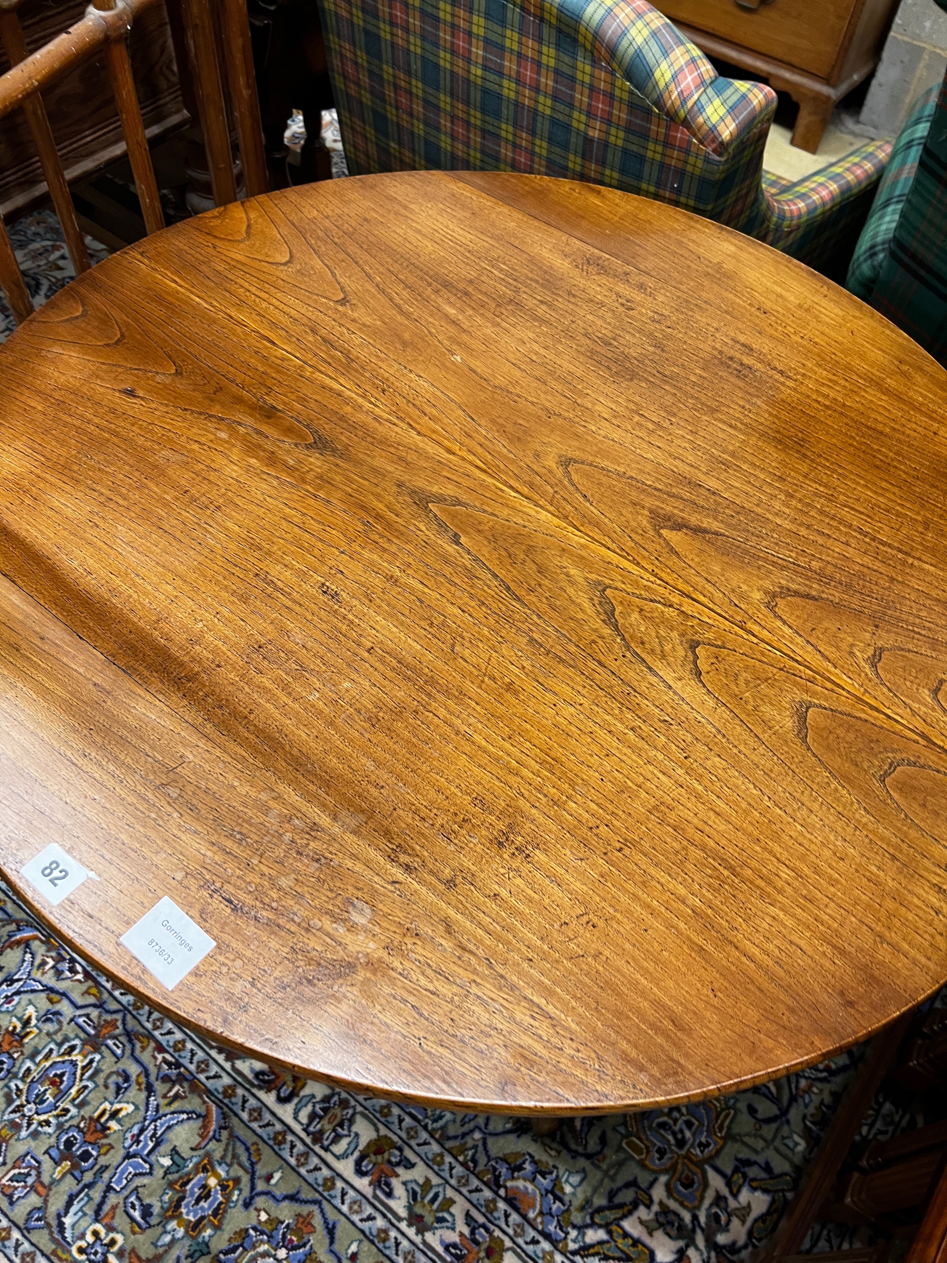 A George III circular oak tilt top tripod tea table, diameter 80cm, height 75cm